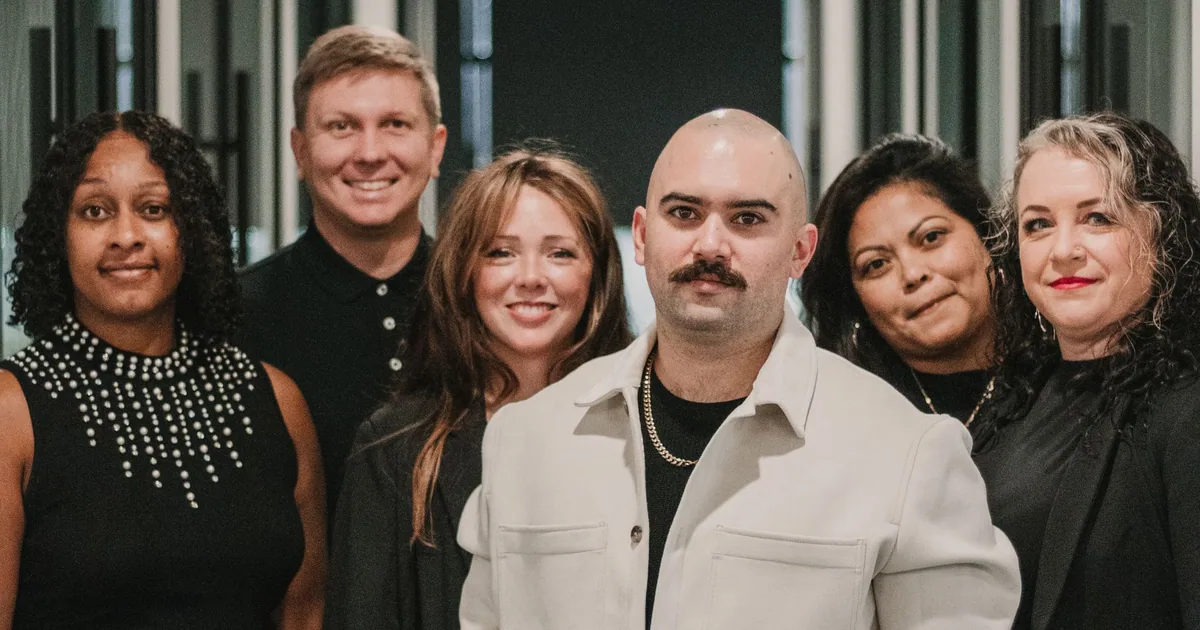 A professional real estate team gathered in a modern office