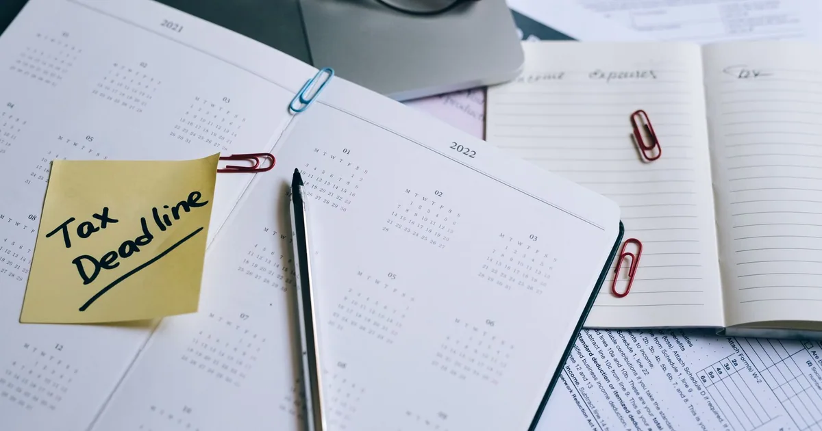 A work planner and deadline reminder arranged on an office desk