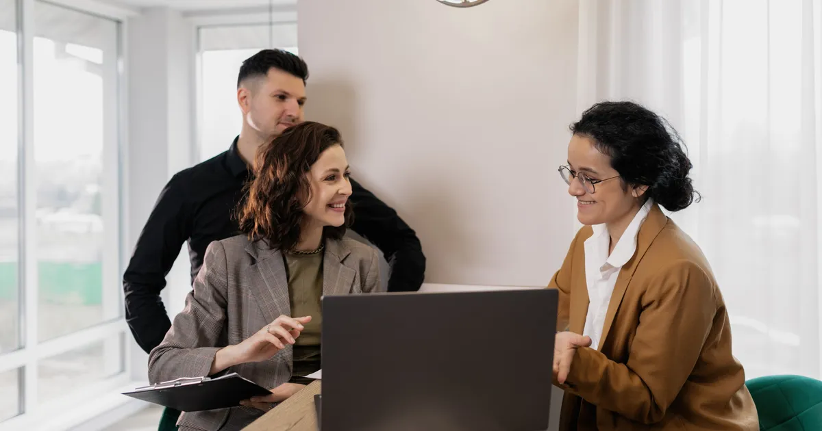 A real estate professional meeting with clients in a bright office